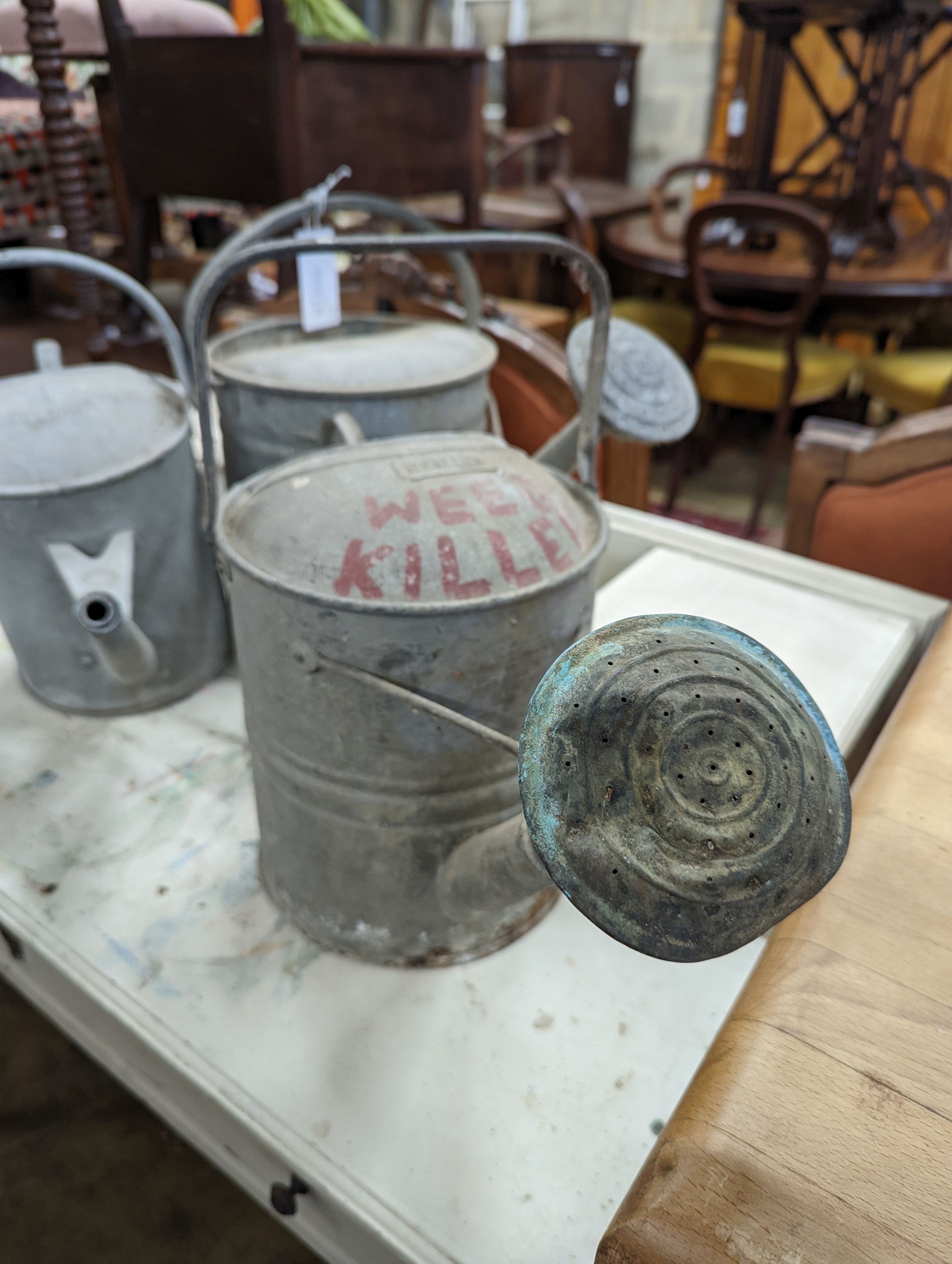 Three vintage galvanized watering cans